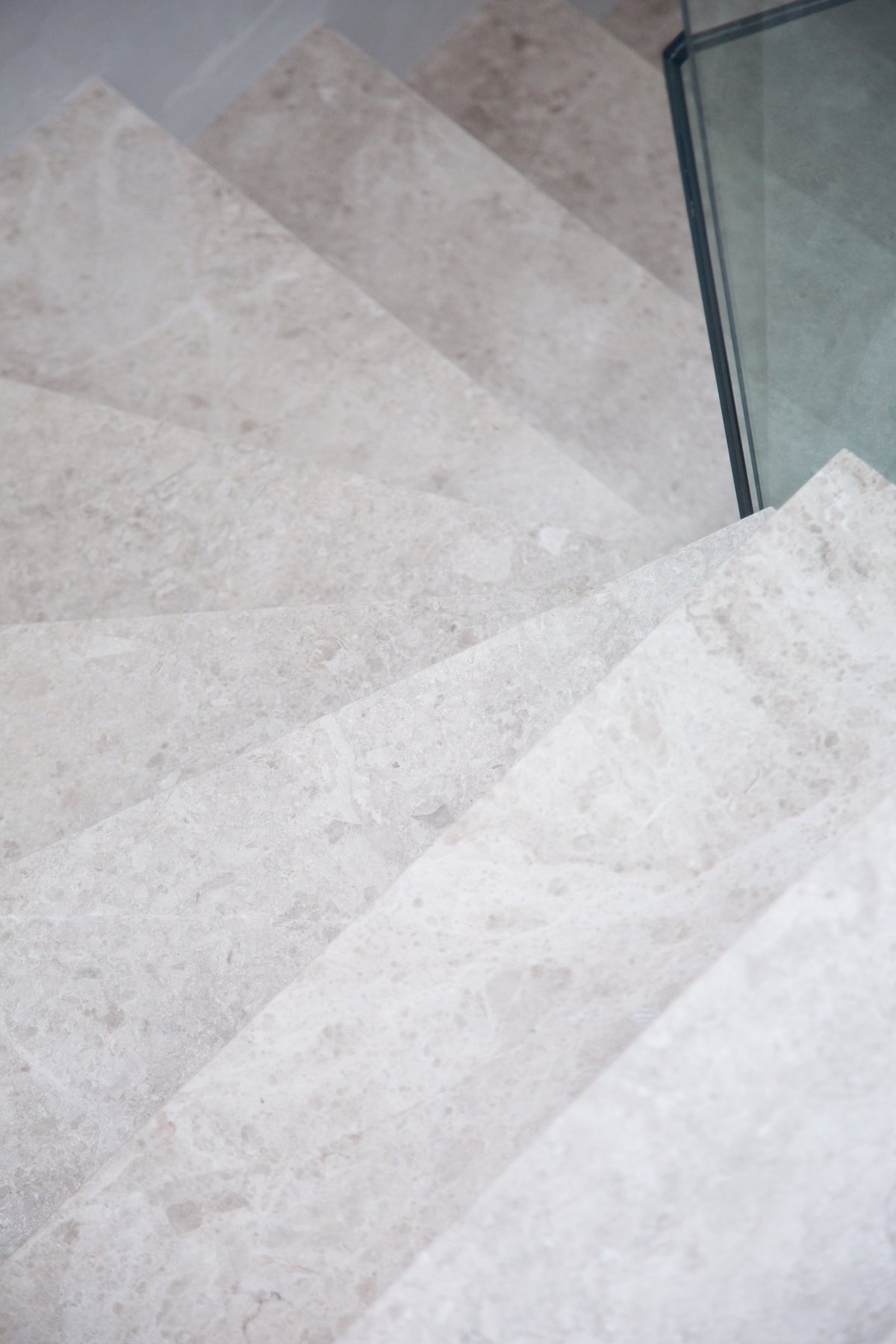 Close-up of Piccadilly Limestone Honed Slab staircase treads showing the soft cream and mink tones of the stone