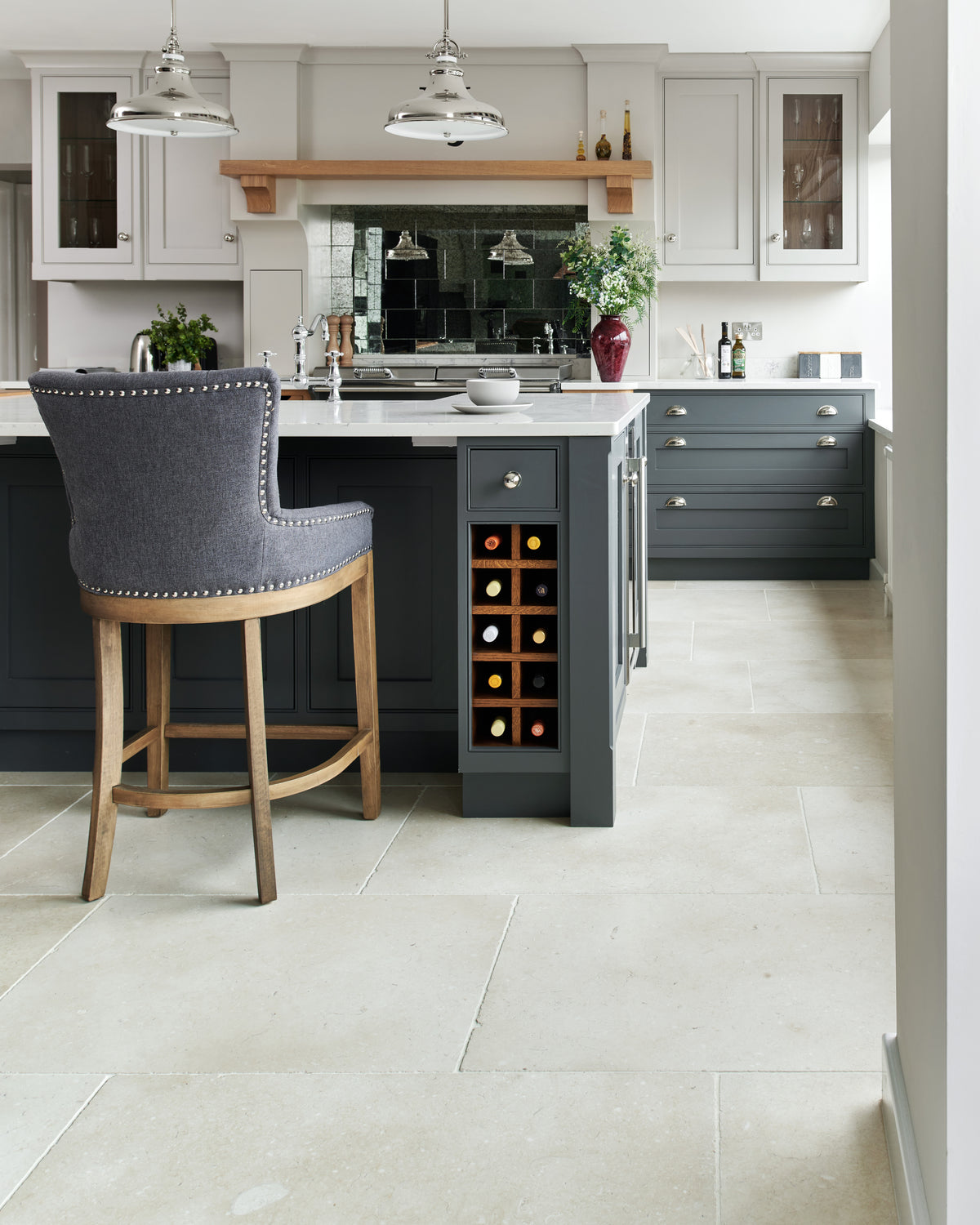 Bergamo Limestone Lightly Seasoned Finish 60 x Random flagstones running through a shaker kitchen with a charcoal island and antiqued mirror splashback