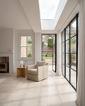 Bergamo Limestone Lightly Seasoned Finish 60 x Random flagstones in a bright living room extension with Crittall doors onto a garden