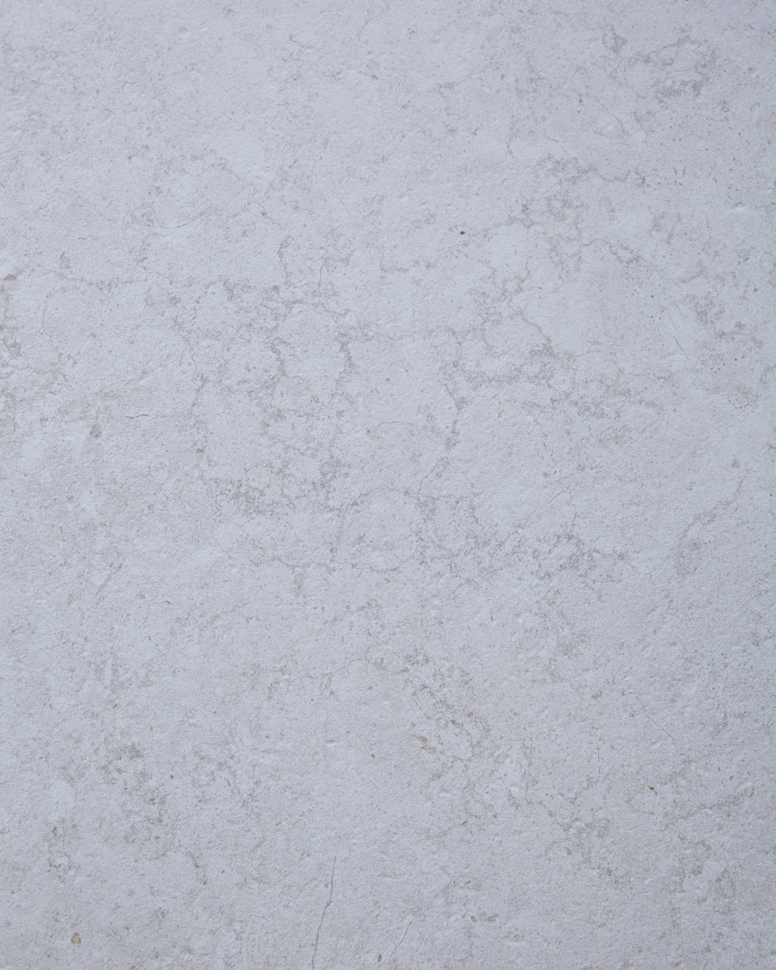Close-up of the Brit Stone Minster Porcelain surface, showing its soft pale limestone tone and fine mottled veining