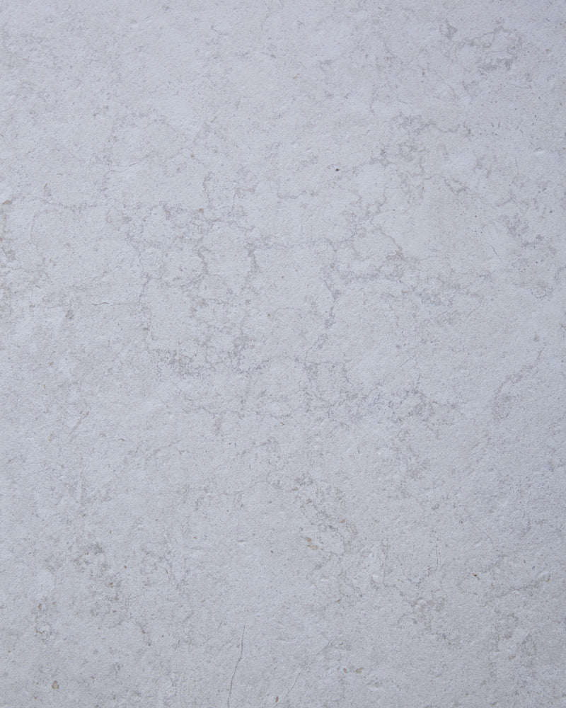 Close-up of the Brit Stone Minster Porcelain surface, showing its soft pale limestone tone and fine mottled veining