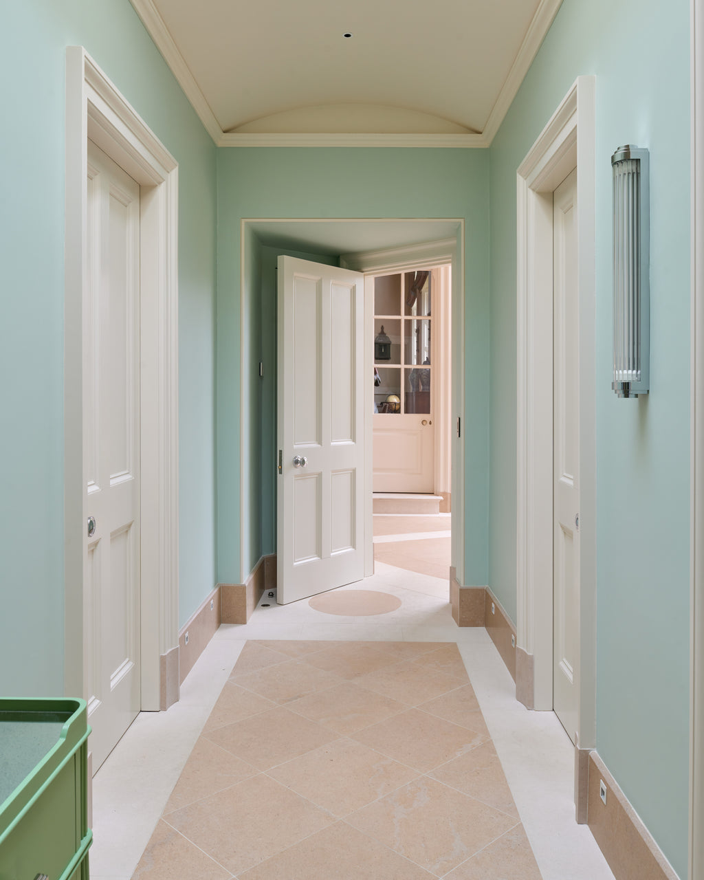 Buscot Limestone Etched Finish floor tiles laid on the diagonal in a soft green corridor with a barrel-vaulted ceiling