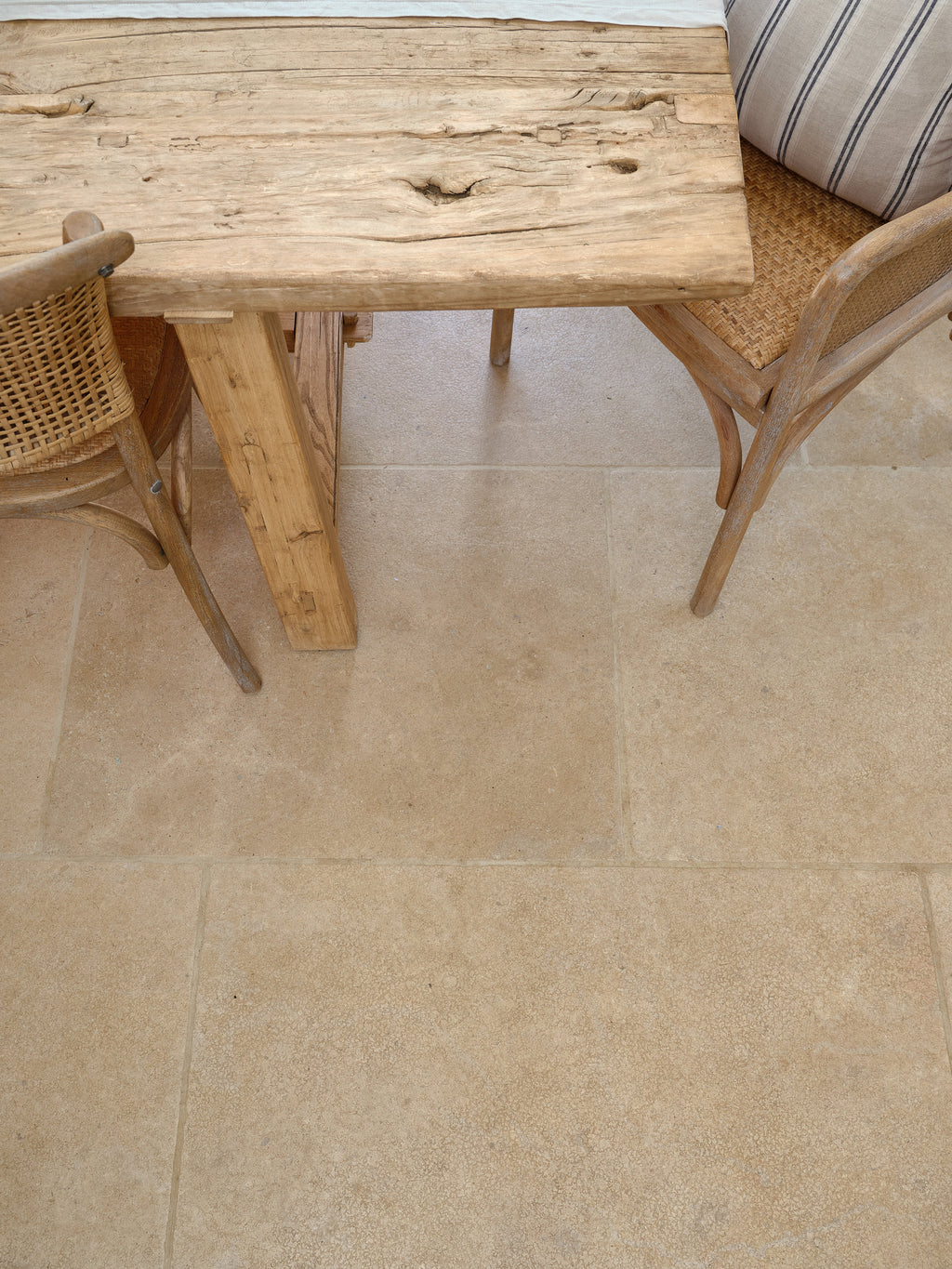 Close detail of Buscot Limestone Tumbled & Etched flagstones showing the honey-beige tone and softly eased edges