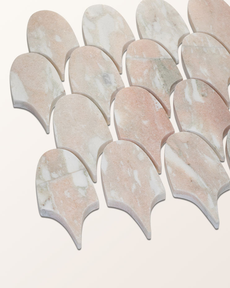East Java Flamingo Marble Plume Mosaic pieces photographed at an angle on a plain background, showing the cut edge and thickness of each feather shape