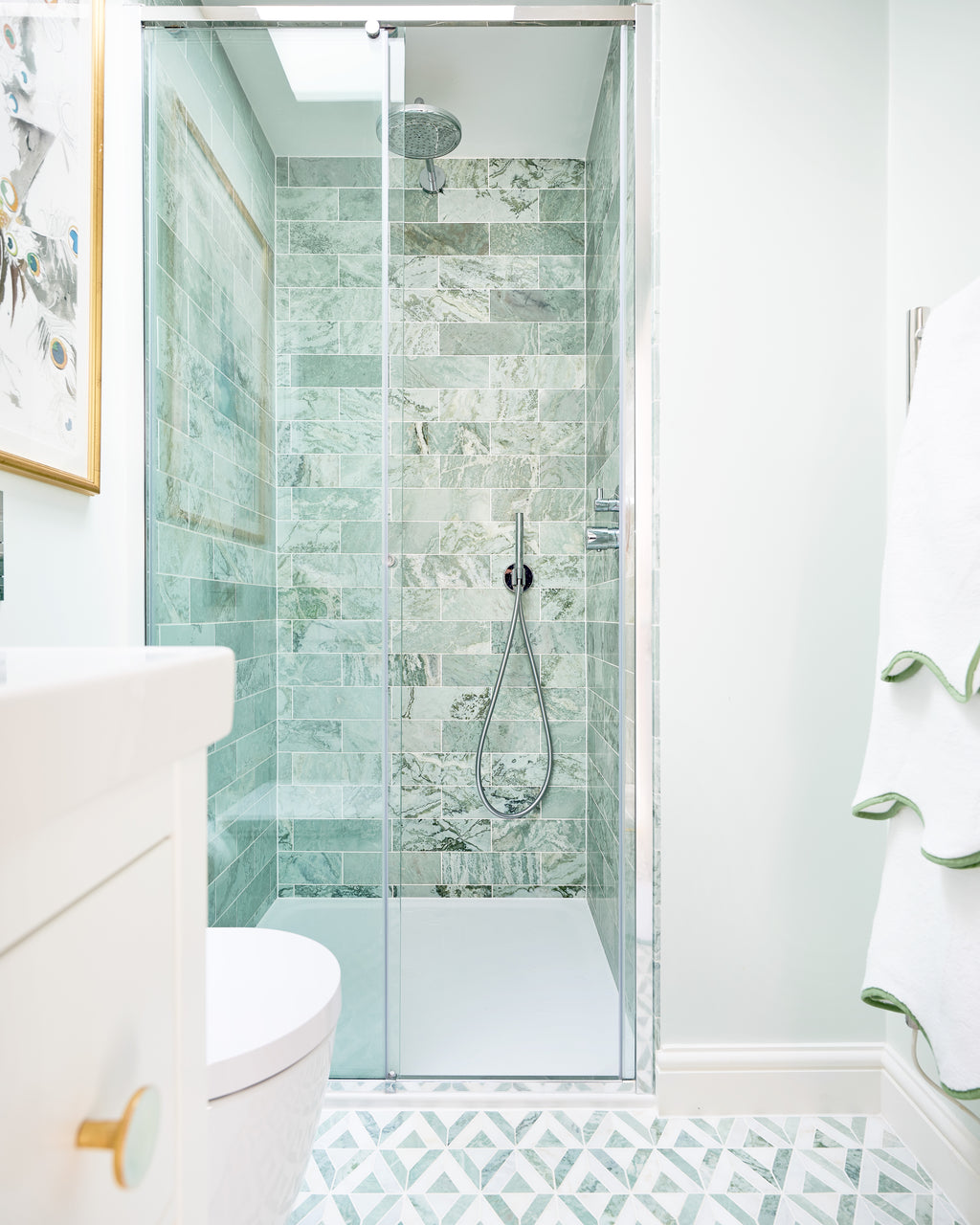 East Java Hummingbird Marble Honed Brick lining a narrow shower enclosure in a white ensuite, with an East Java Hummingbird Marble Temple Mosaic floor running up to the tray