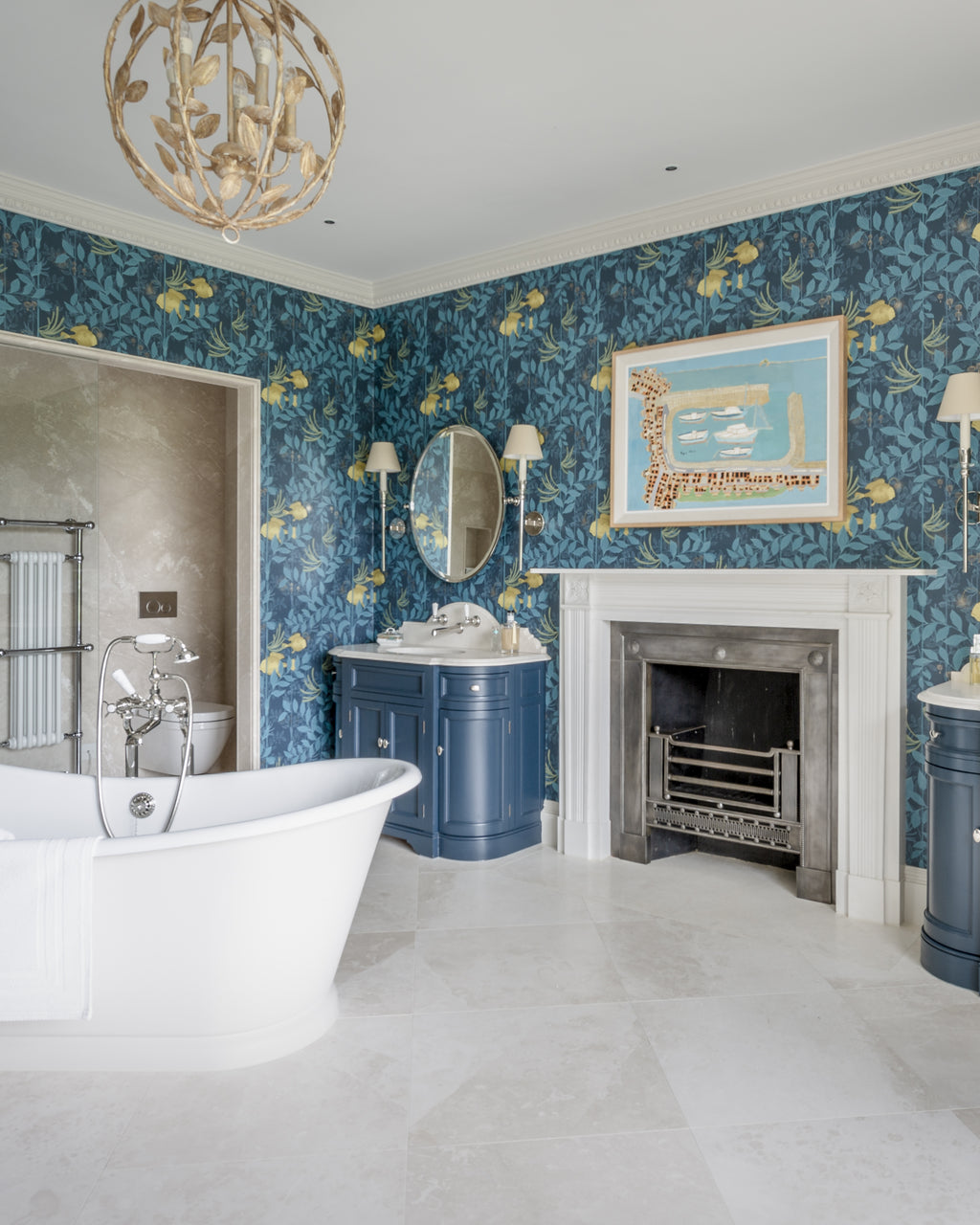 Folio Marble Honed Finish across the floor of a large master bathroom with a freestanding roll-top bath, marble fireplace and deep blue floral wallpaper