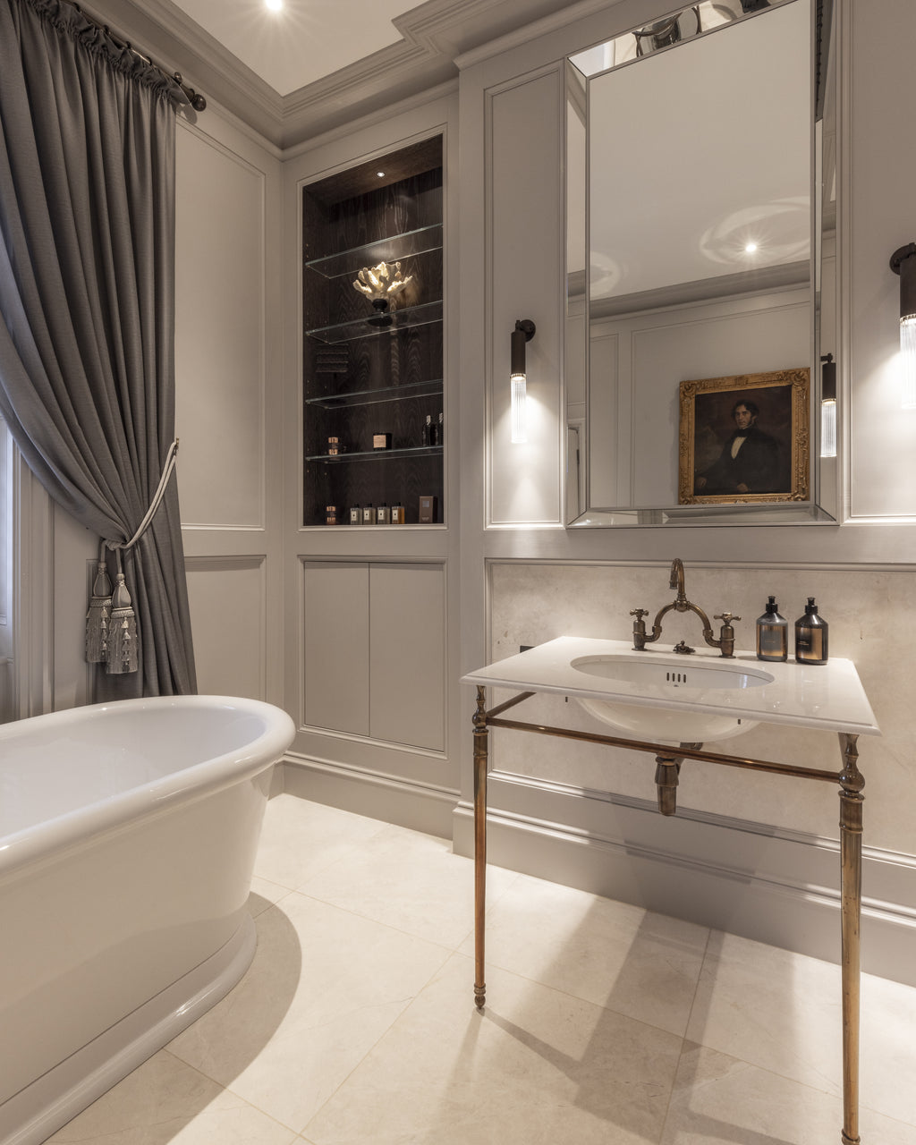 Folio Marble Honed Finish floor in a softly panelled bathroom with a freestanding bath and an antique brass washstand