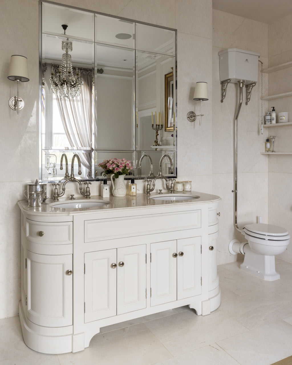 Folio Marble Honed Finish on the floor and walls of a cream bathroom with a curved double vanity and high-level cistern