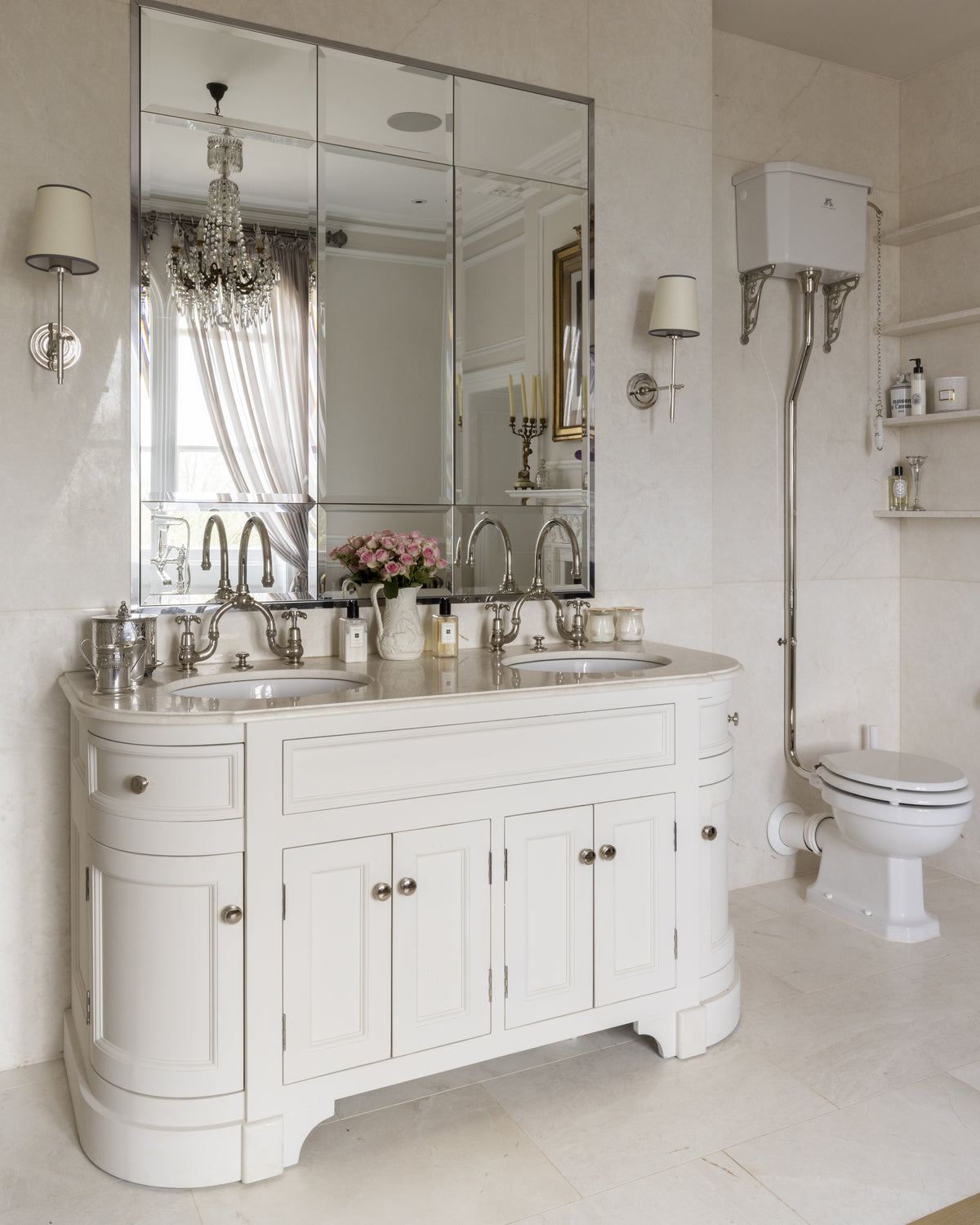 Folio Marble Honed Finish on the floor and walls of a cream bathroom with a curved double vanity and high-level cistern