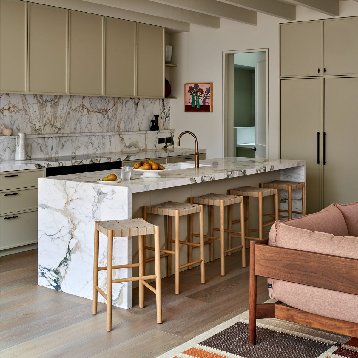 Garden House - kitchen island with Calacatta Gold marble waterfall edge and woven oak bar stools