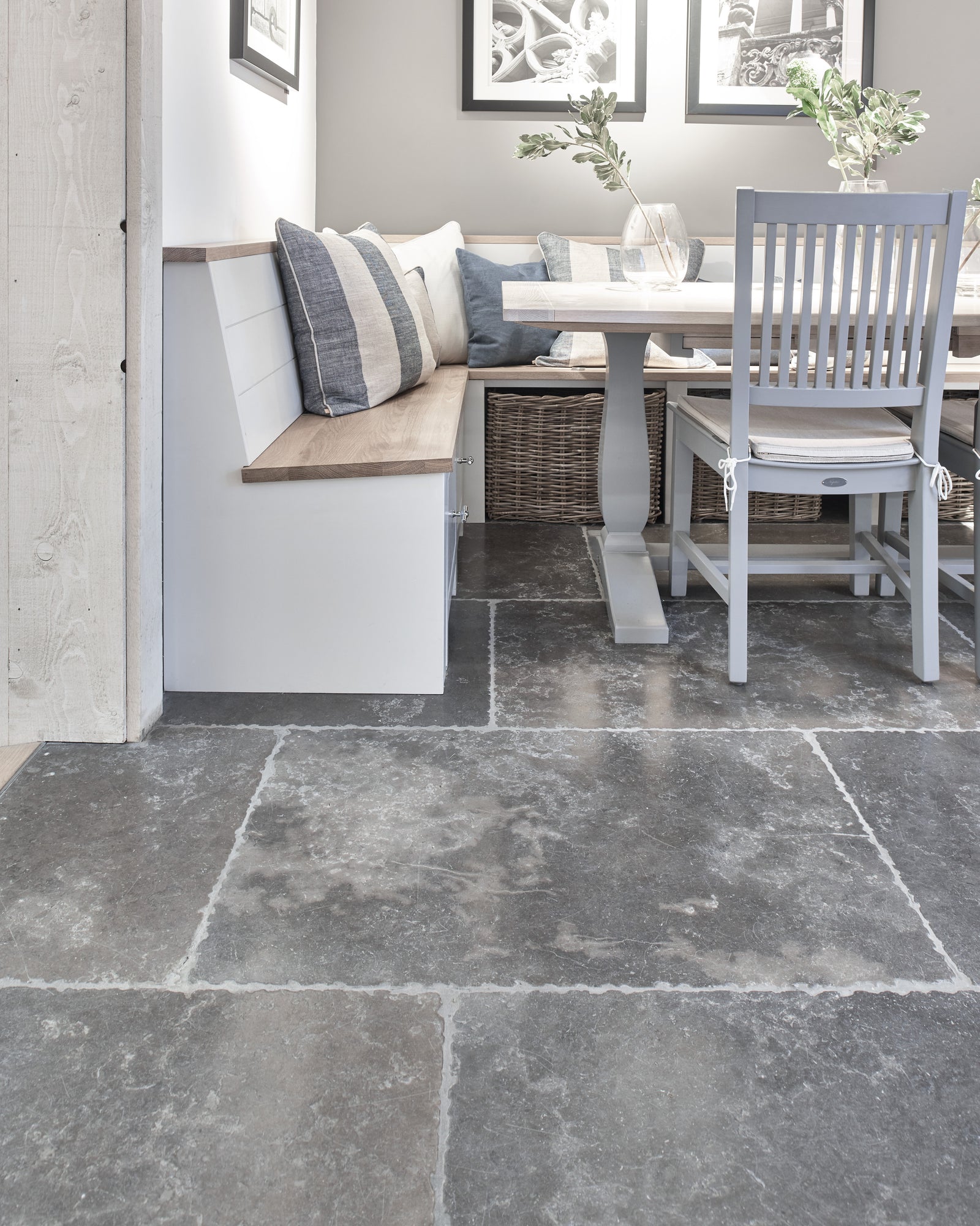 Hazlebury Limestone Seasoned Finish flagstones in a kitchen dining corner with a built-in banquette and pale oak table