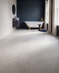 Himalaya Porcelain Crystal Textured in large format across a bathroom floor, with a gold-footed roll-top bath against a deep blue tiled wall and a fluted white wall behind the vanity
