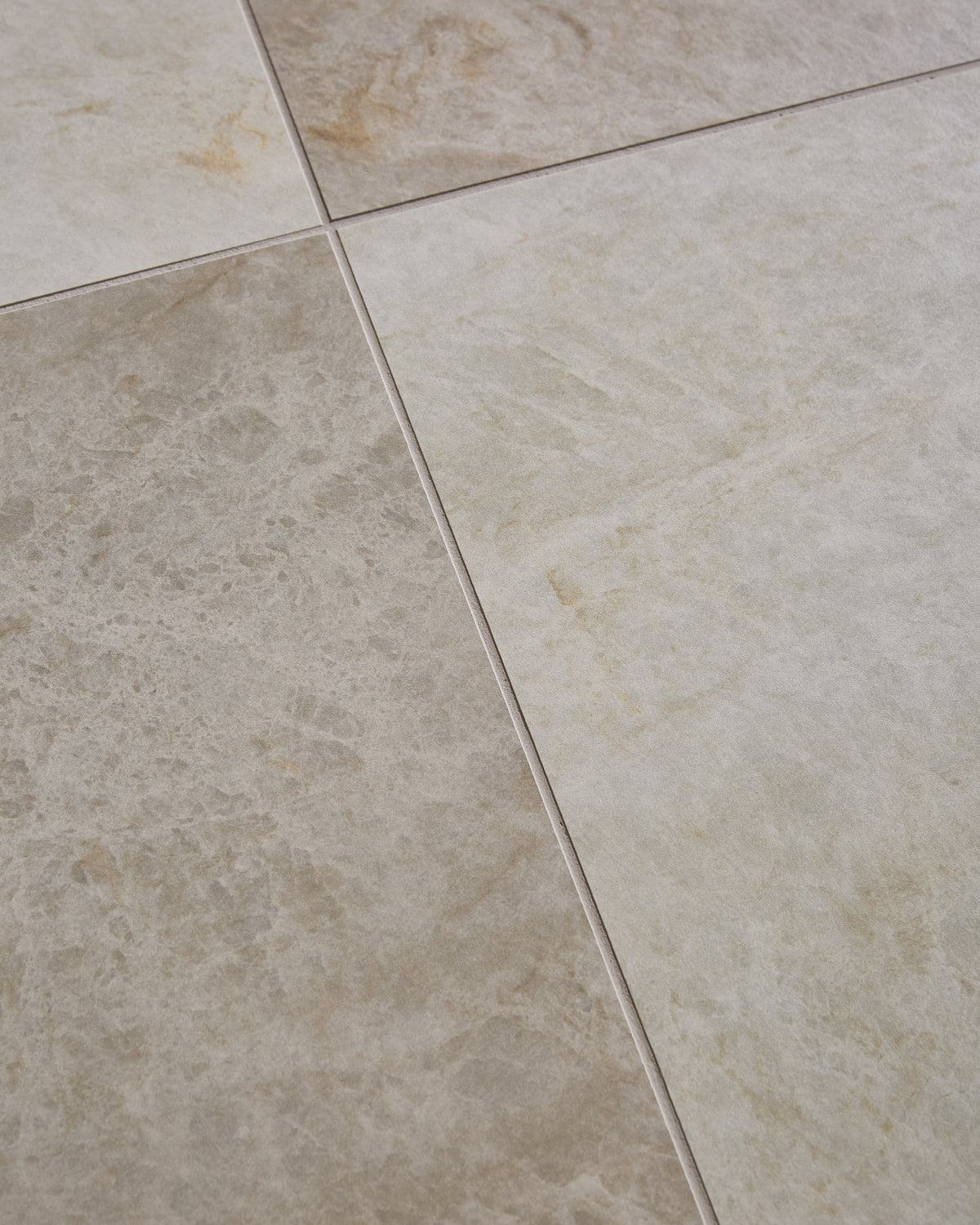 Hoxton Porcelain Amber Matt floor tiles laid on the diagonal, close up on the joint where four tiles meet, showing the warm sand and ochre tones in the surface