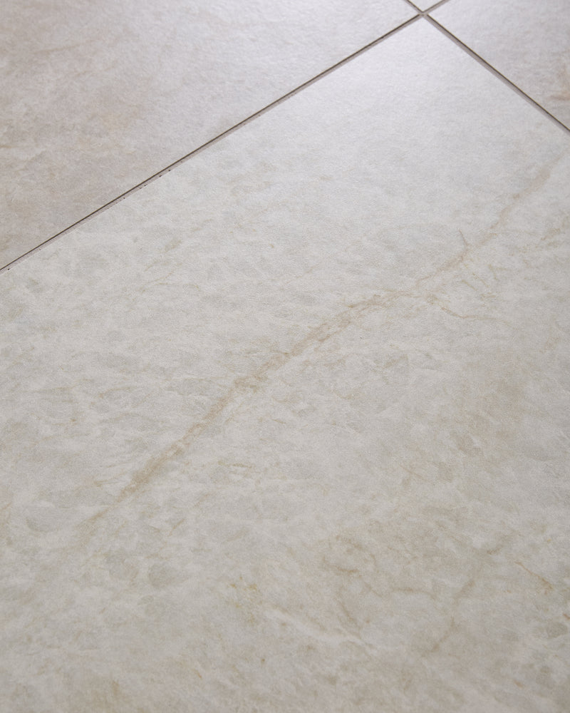 Hoxton Porcelain Linen Matt shown close up across a single large tile, with the pale linen surface and warm sandy veining running diagonally through it