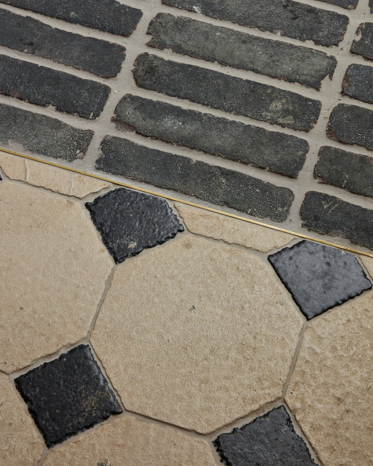 Limoges Limestone Vintaged Finish octagon floor meeting a dark brick paved border inside a hotel lounge