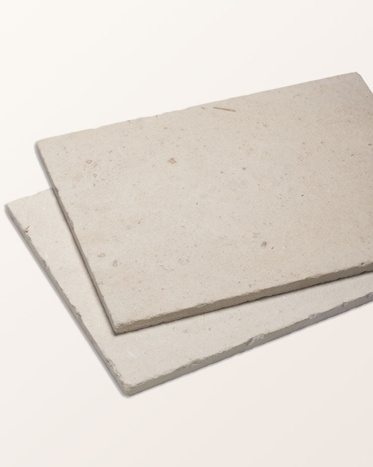 Two Limoges Limestone Vintaged Finish tiles stacked to show the vintaged face and the chipped edge profile