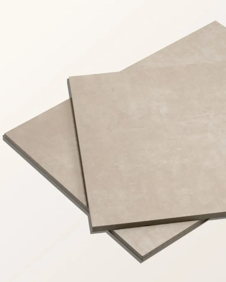 Two Loft Porcelain Pearl tiles stacked at an angle on a cream background, showing the soft mottled surface and tile edge profile