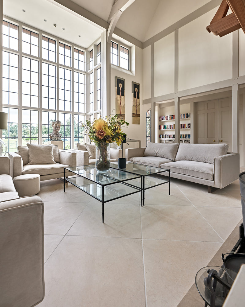 Mallory Limestone Tumbled Finish flagstones across a double-height drawing room with tall steel windows and a vaulted oak-trussed ceiling
