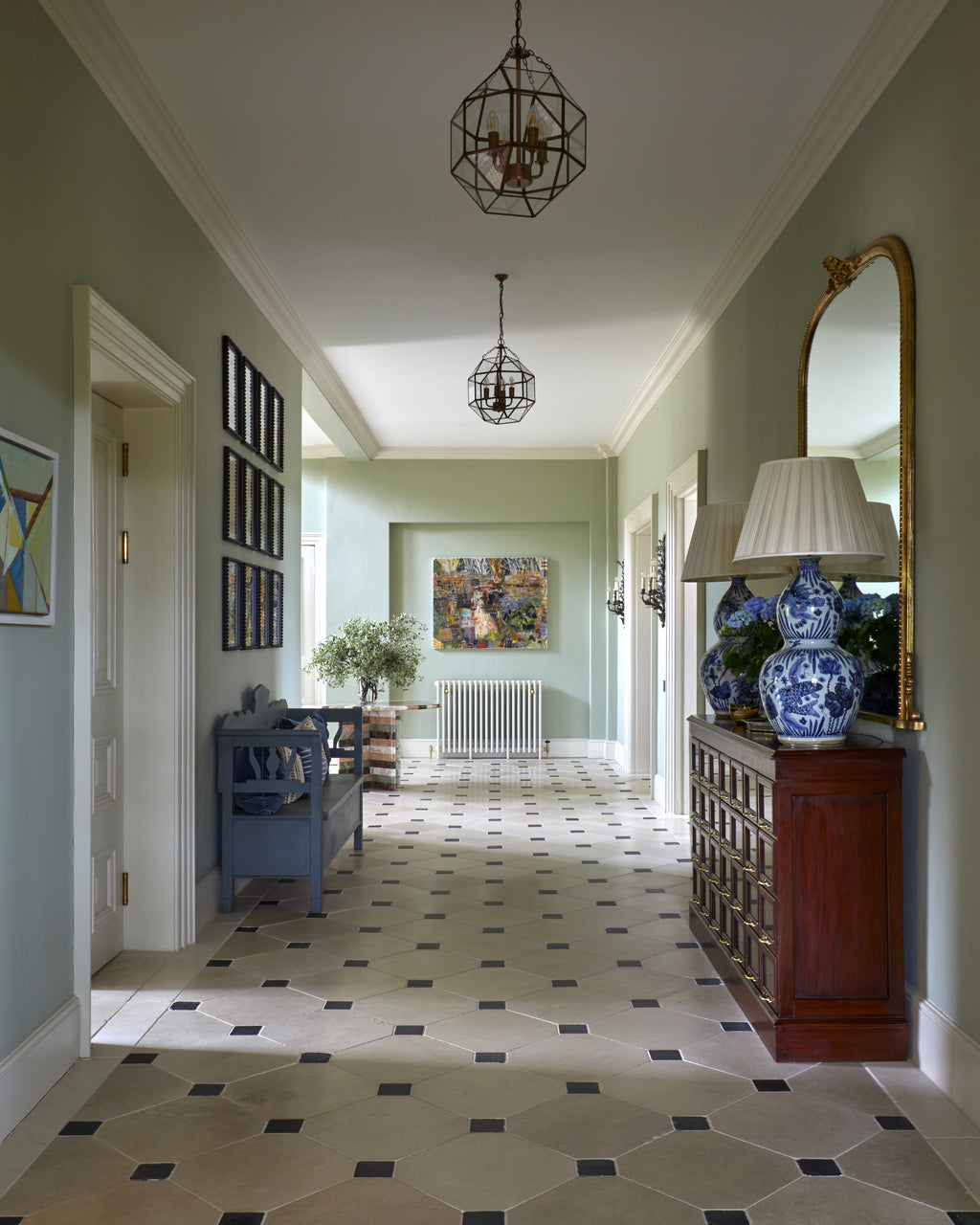 Mallory Limestone Tumbled Finish laid in an octagon and cabochon pattern along a green panelled hallway with glazed lanterns