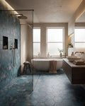 Mermaid's Garden Porcelain running across the floor and up the shower wall of a plastered bathroom with a freestanding stone bath and brass fittings