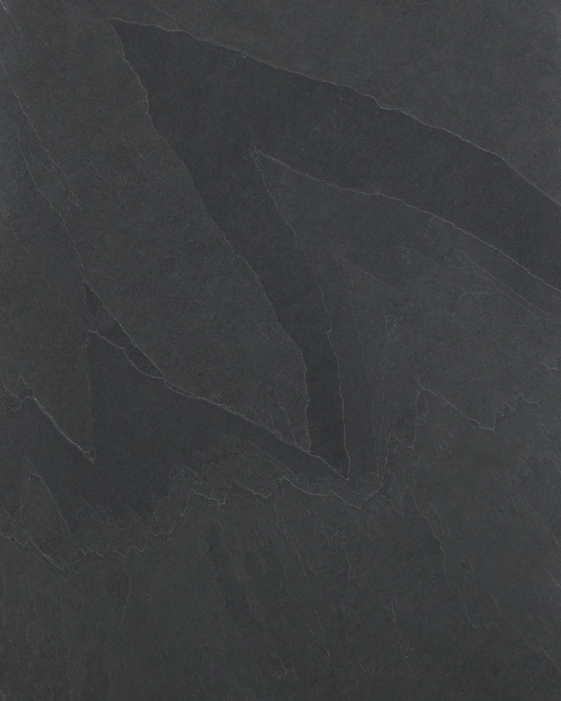 Close-up of the Metropolitan Slate Riven Slab surface, showing the charcoal tone and the cleft ridges and pale seams of the riven finish