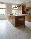 Muscat Porcelain Satin flooring in a terracotta painted kitchen with a marble topped island and aged brass pendant lights