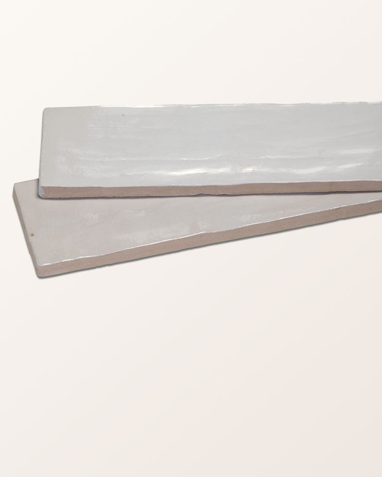 Oasis Ceramic White Gloss, two tiles stacked at an angle on a plain background to show the glossy face and the ceramic body edge