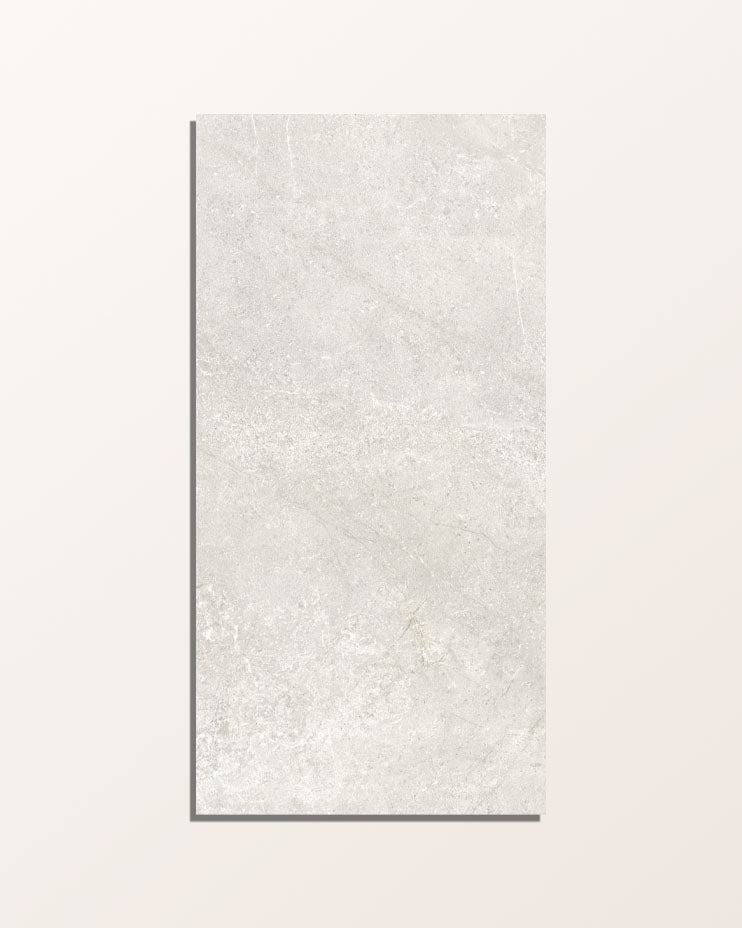 Single Riverside Porcelain Perla 60 x 120cm tile shown face on against a pale background, showing the soft grey stone-effect surface