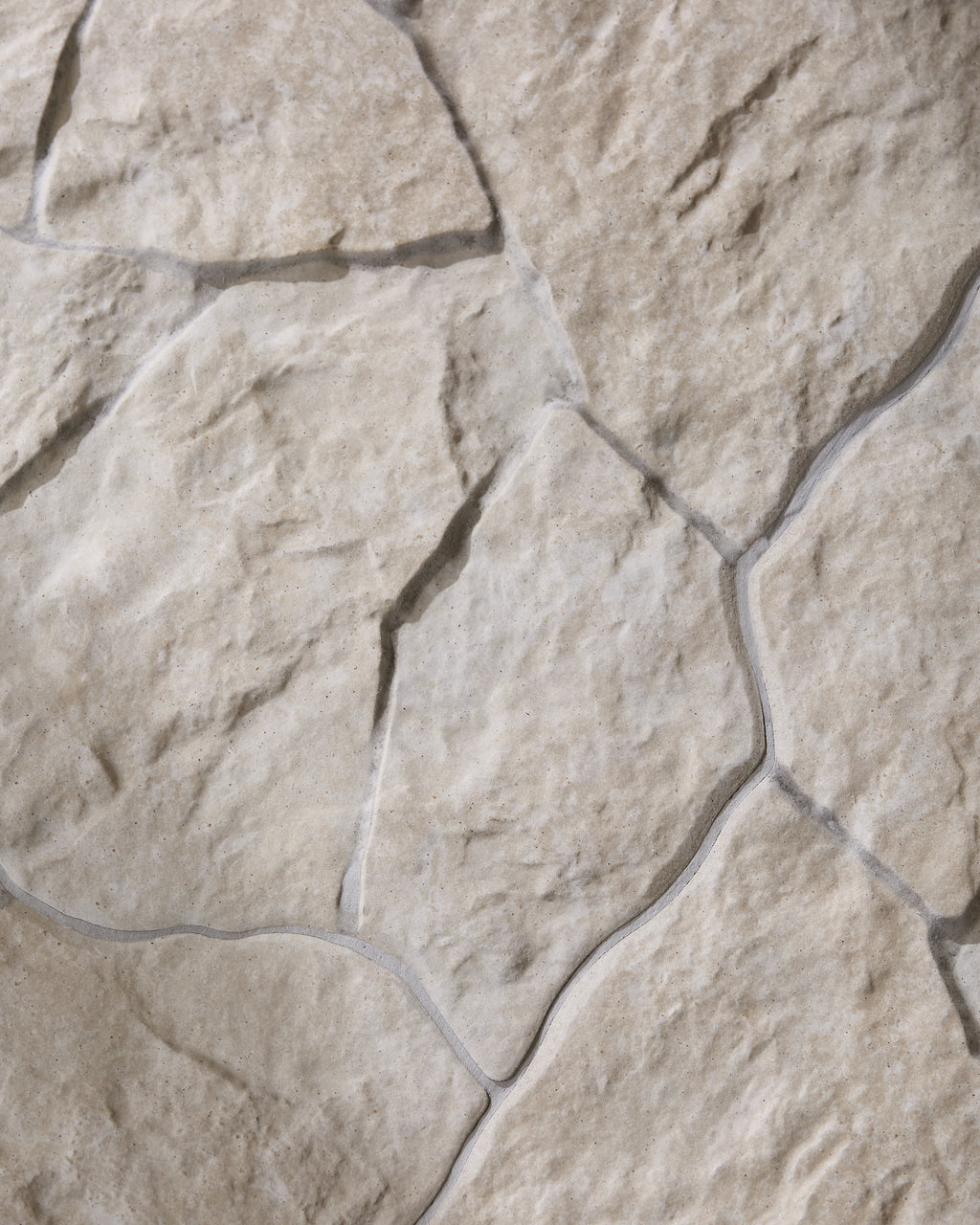 Sierra Porcelain Textured seen from above, the random crazy paving pattern running across the frame with pale grout lines tracing the irregular edges