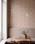 STUDIO Sanderson Anaar Pink Clay tiles running full height across a window-lit banquette corner, with a linen bench, worn wooden table and olive sprigs in a stoneware jug
