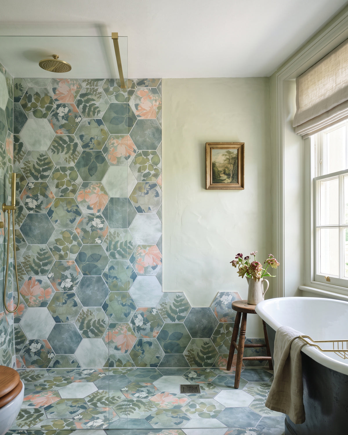 Woodland Glade Porcelain running full height up a walk-in shower wall and across the floor beside a cast iron bath