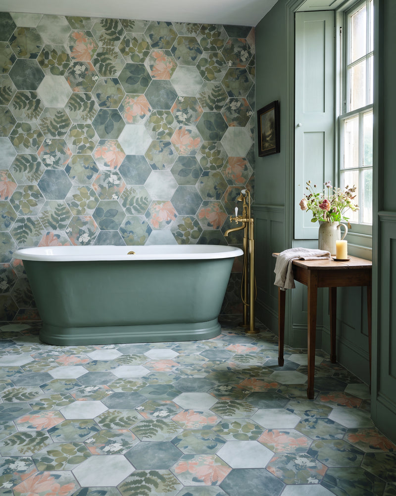 Woodland Glade Porcelain on the wall and floor of a green panelled bathroom with a sage freestanding bath and brass taps